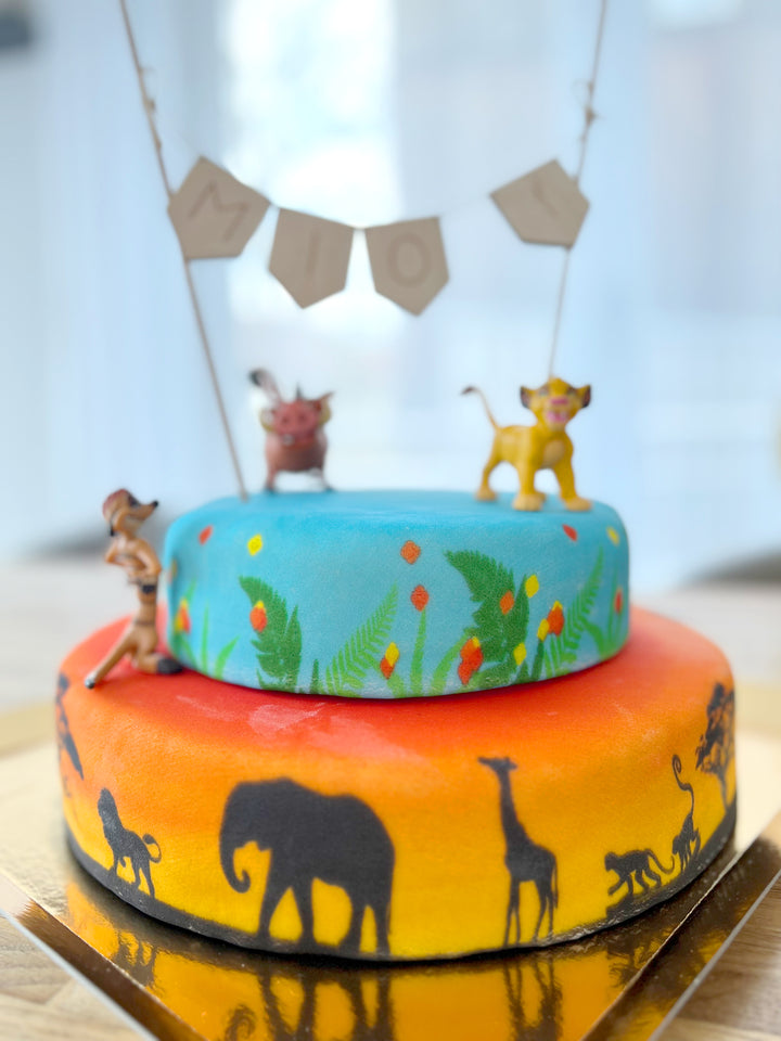 Simba®, Timon & Pumbaa® on a 2-tier savannah cake