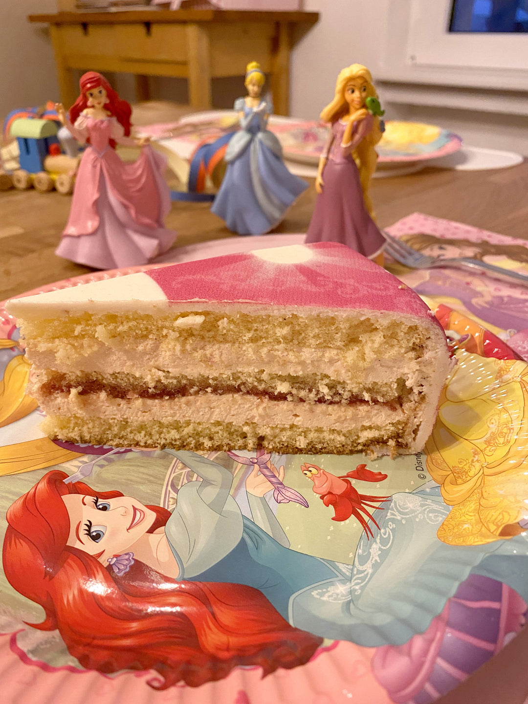 3 Princesses on a two-tier cake with a ribbon