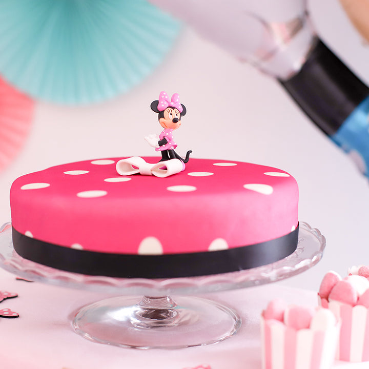 Minnie® Mouse on polka dot cake with ribbon