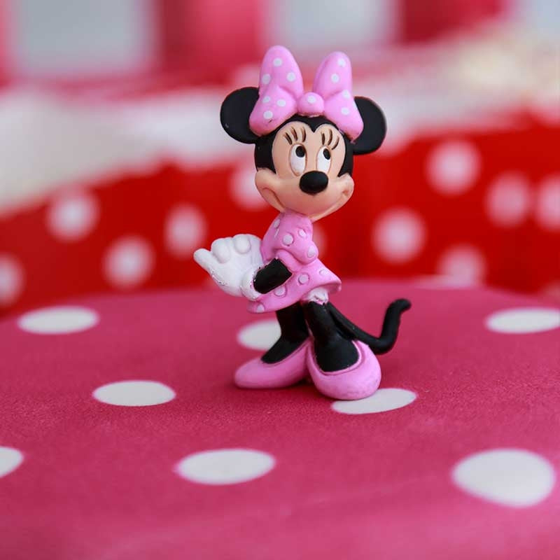Minnie® Mouse on polka dot cake with ribbon