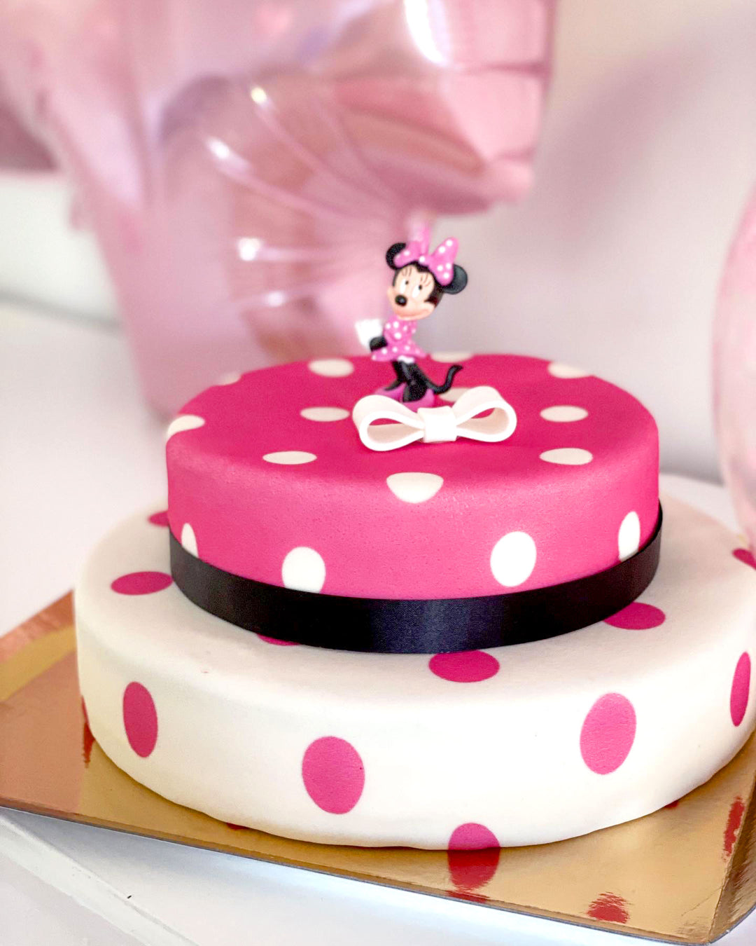 Minnie Mouse® on a 2-tier polka dot cake