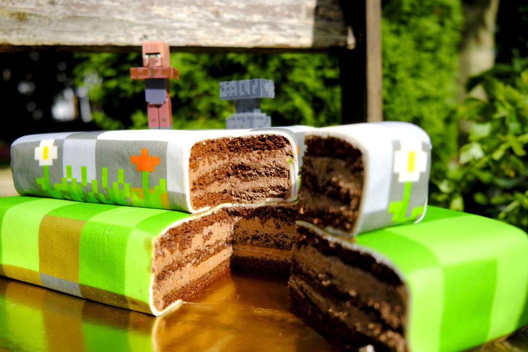 Minecraft® figure on a two-tier game world cake