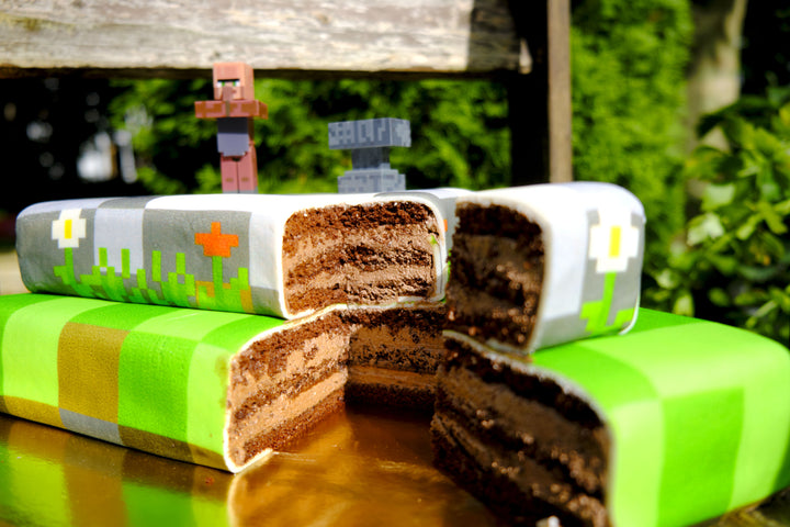 Minecraft® figure on a two-tier game world cake