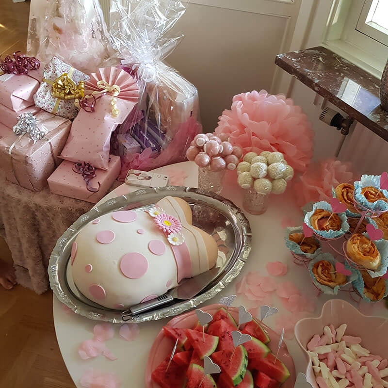 Baby bump cake with pink ribbon