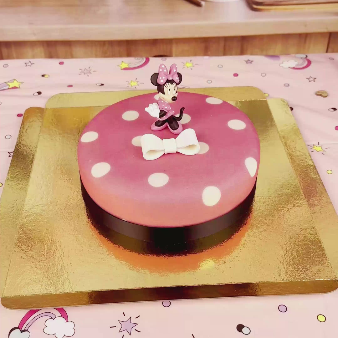 Minnie® Mouse on polka dot cake with ribbon