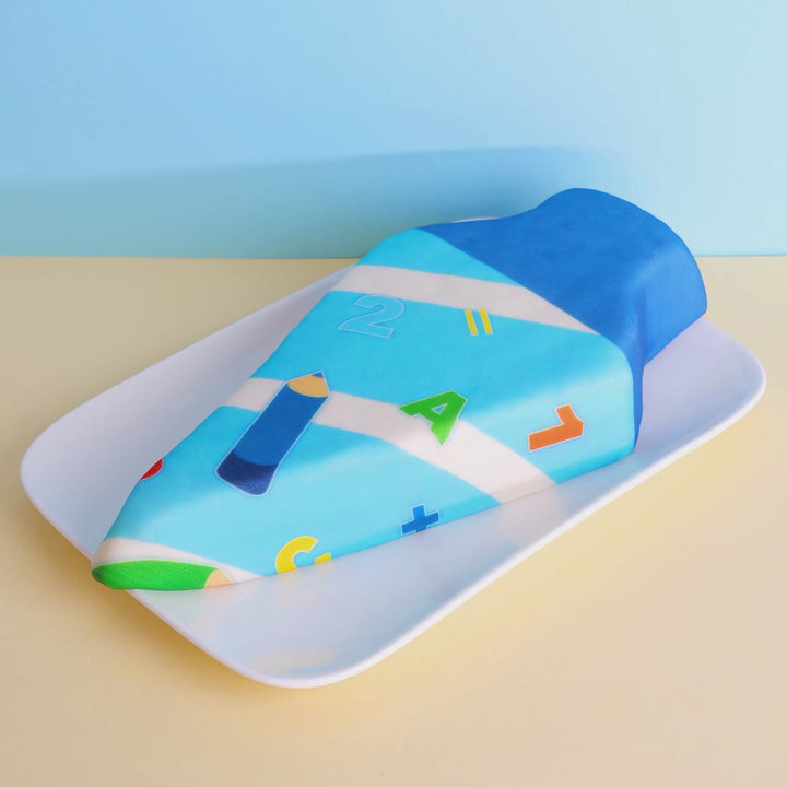 School cone cake with light blue pens