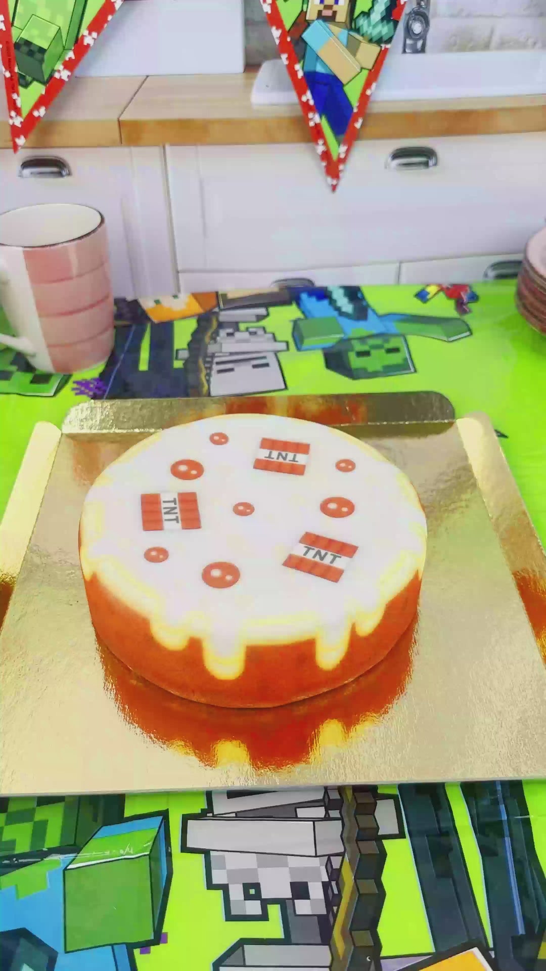 Minecraft® figure on a round TNT cake