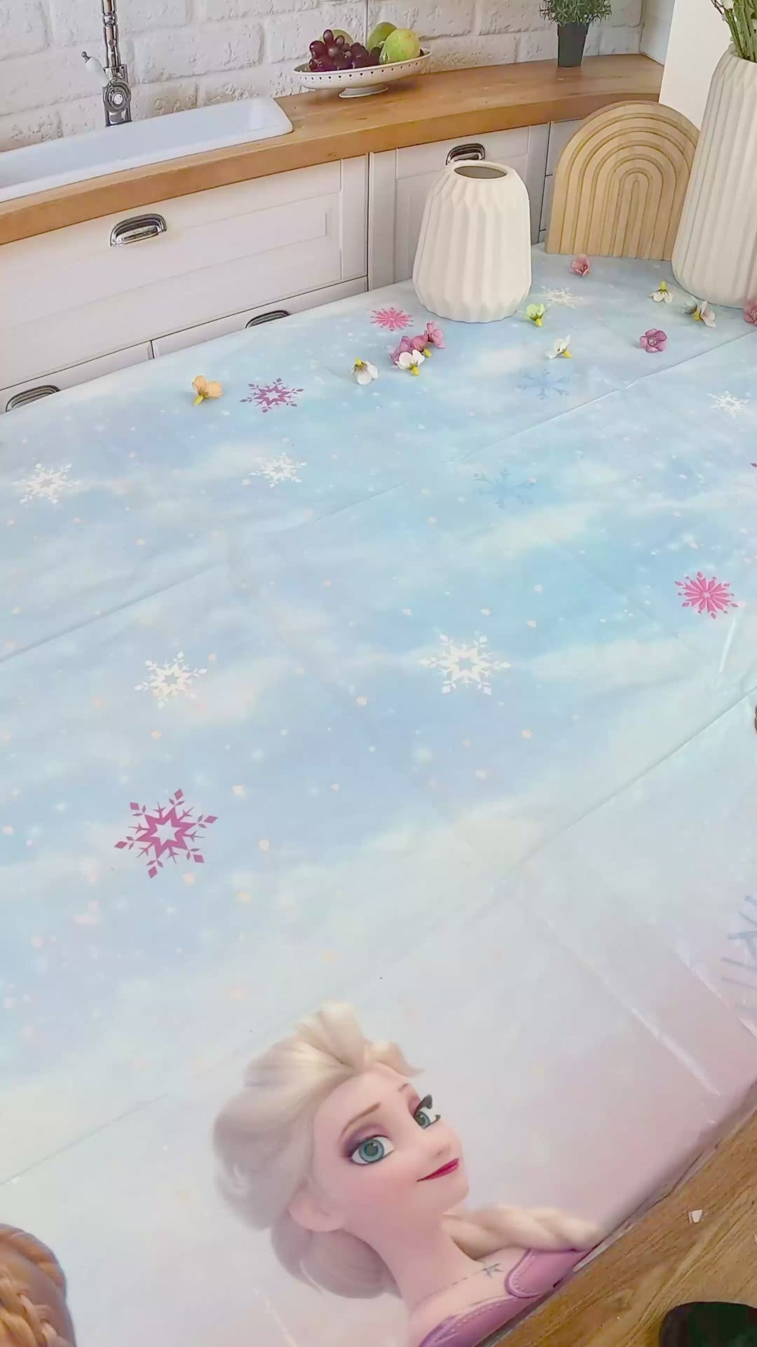 Anna and Elsa from Frozen® on a snowflake cake