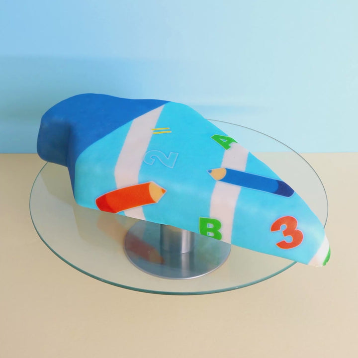 School cone cake with light blue pens