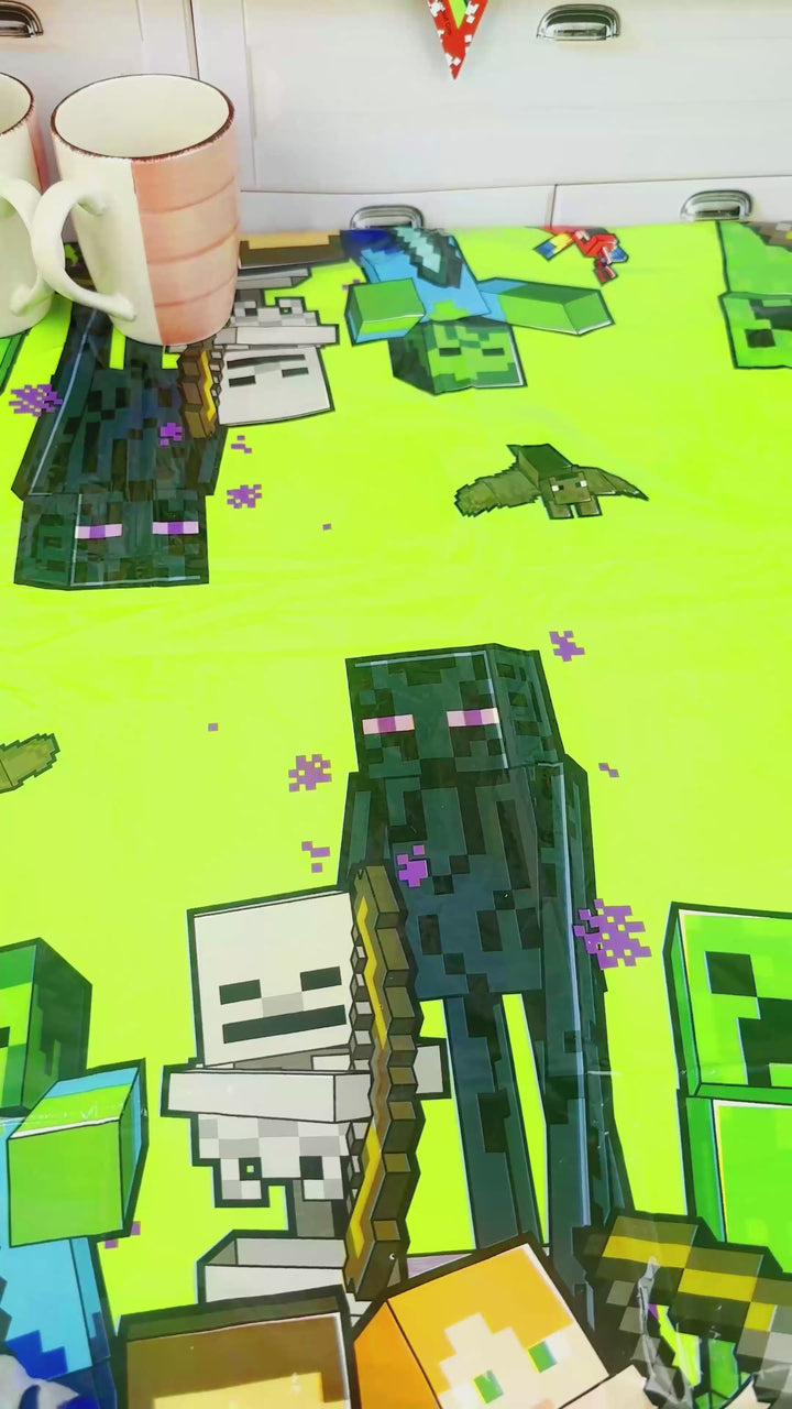 Minecraft® figure on a two-tier game world cake