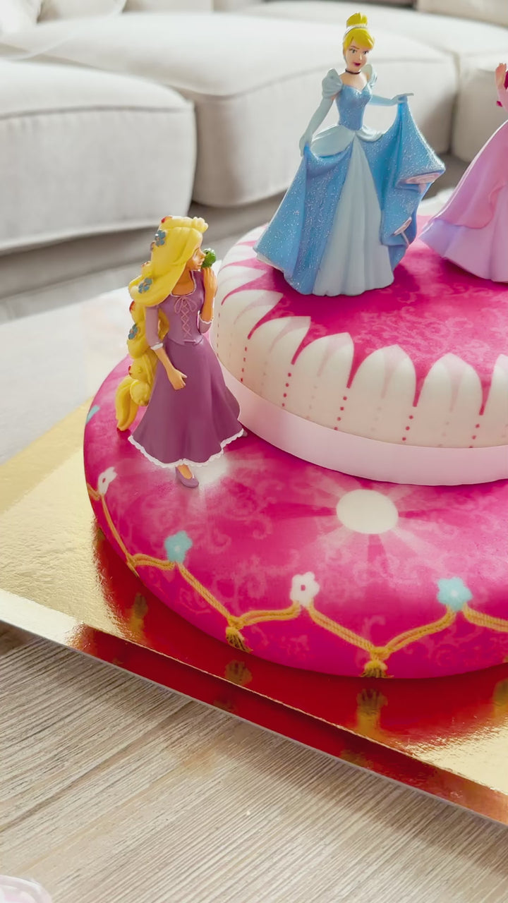 3 Princesses on a two-tier cake with a ribbon