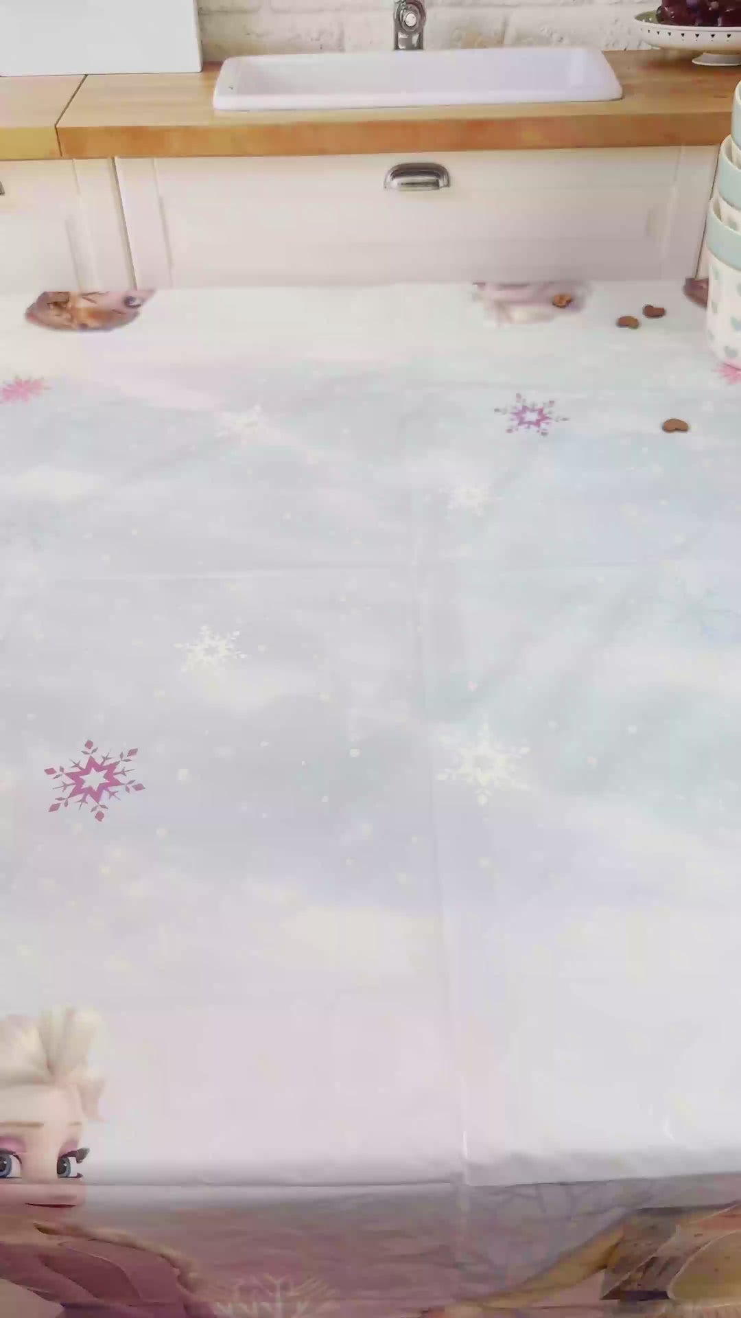 Frozen® Elsa, Anna & Olaf figures on a 2-tier snowflake cake