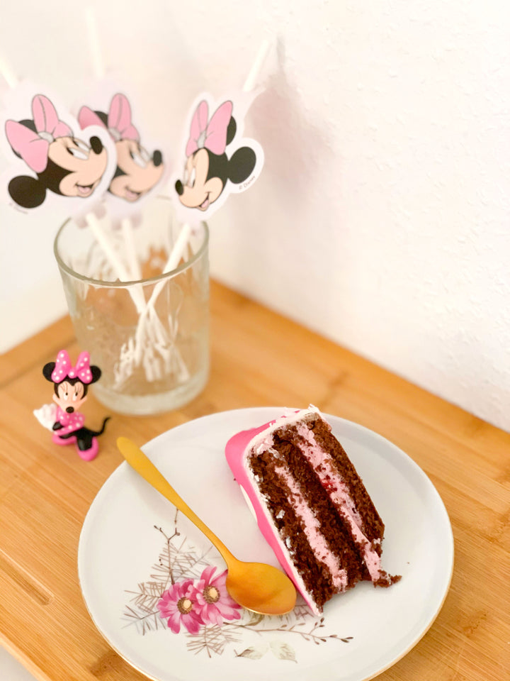 Minnie® Mouse on polka dot cake with ribbon