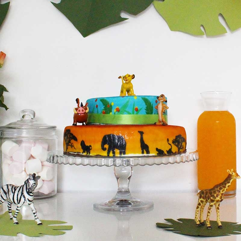 Simba®, Timon & Pumbaa® on a 2-tier savannah cake