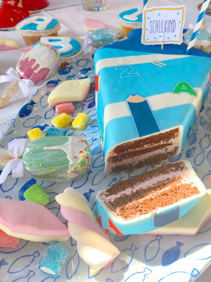 School cone cake with light blue pens