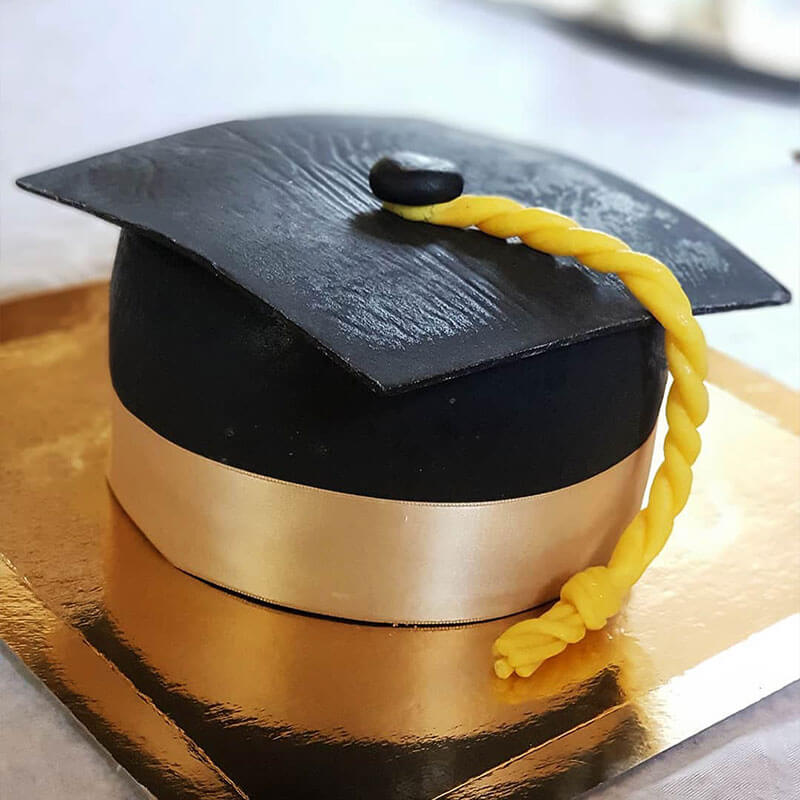 Graduation cake in the shape of a black graduation cap
