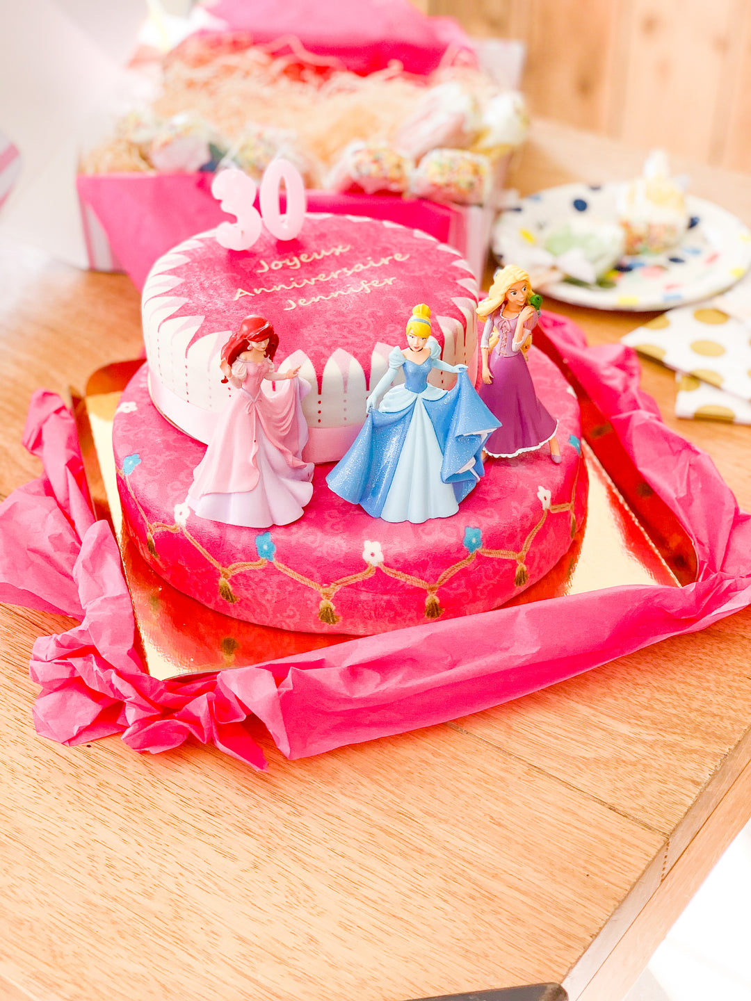 3 Princesses on a two-tier cake with a ribbon