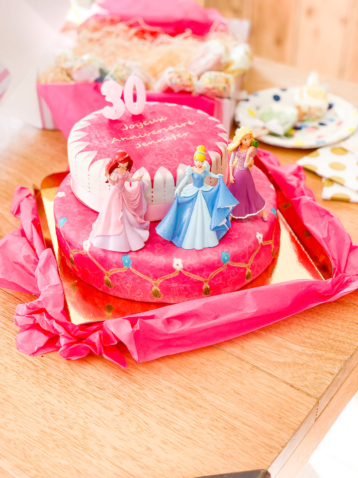3 Princesses on a two-tier cake with a ribbon