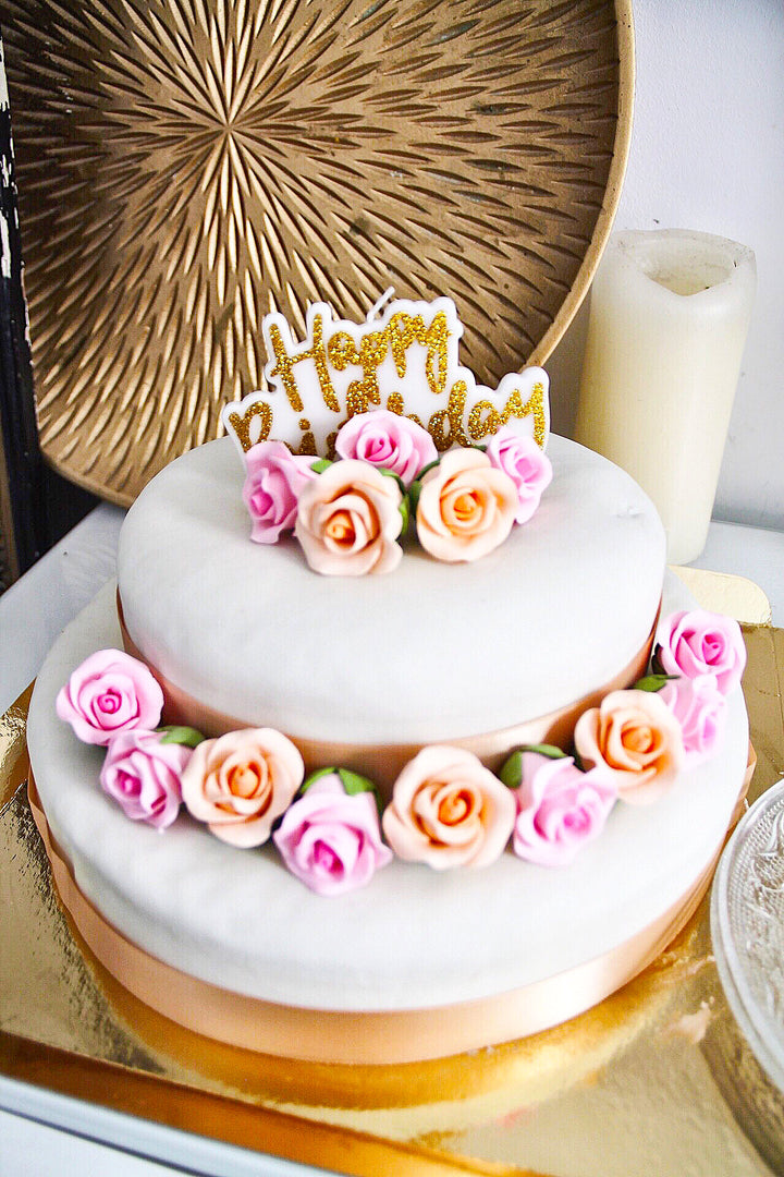Two-tier white cake with cake ribbon